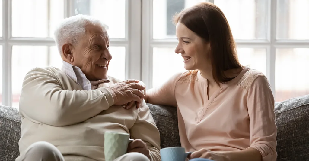 An elderly person discusses end of life care with a loved one prompted by National Hospice and Palliative Care Month